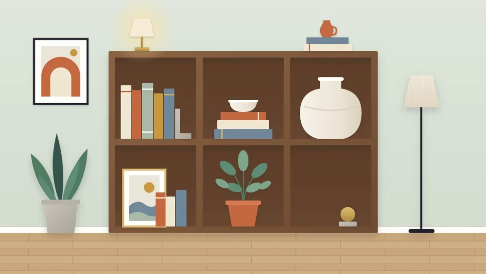 Wide low bookcase with six square cubbies, each styled differently with books, a bowl, a vase, a frame, a plant and open space