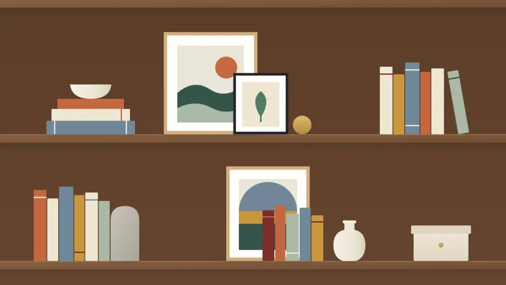 Two shelves with a large leaning frame, a smaller frame overlapping its corner, a row of books in front of another frame and a vase