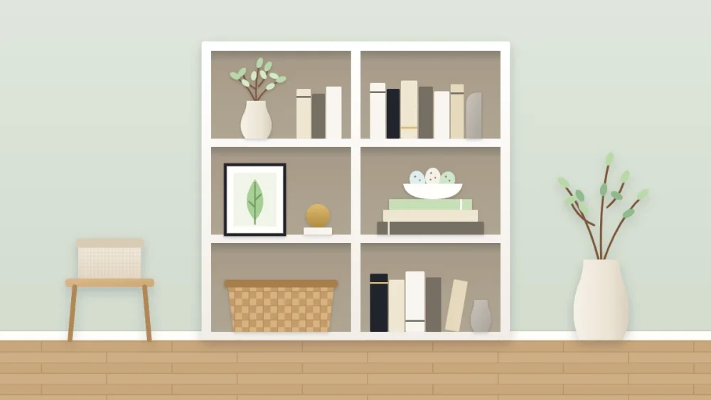 A neutral bookcase with three spring swap spots: a vase of pale green branches, a bowl of speckled egg shapes on a book stack and a framed leaf print