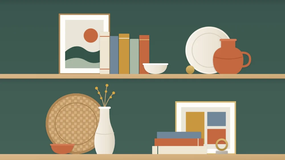 Two deep shelves in layers: a leaning print and woven tray at the back, books and a vase in the middle, a small bowl in front